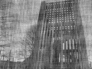 The playground equipment again. The image is darker and is overlaid
with a texturing, almost cloth-like but fuzzy. The grain of the texturing seems
to be about in alignment with the slats.